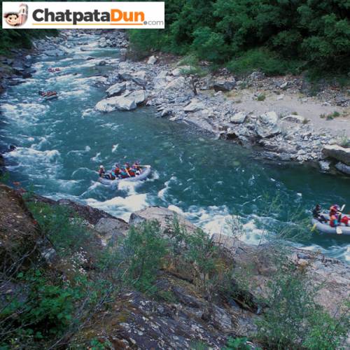 Tourists doing river rafting